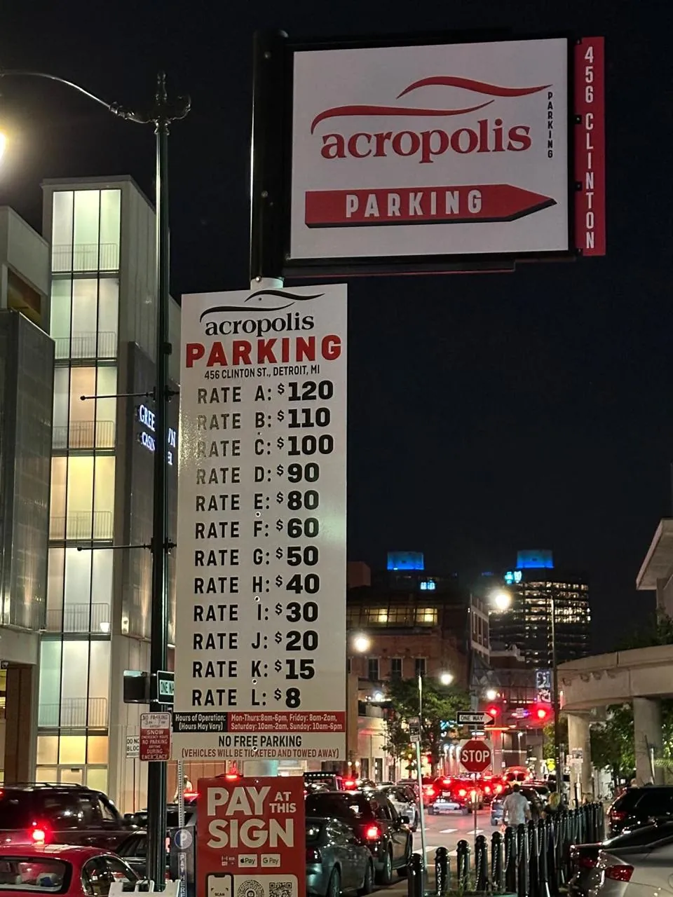 Acropolis Parking rate sign at 456 Clinton St at night